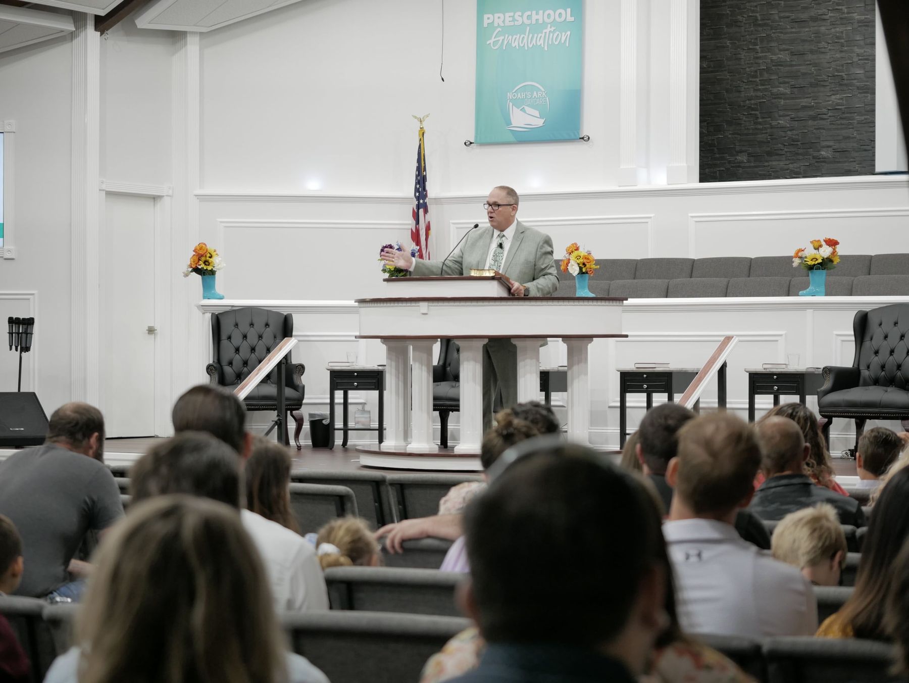 The pastor of North Platte Baptist Church speaking to families at the Noah's Ark preschool graduation