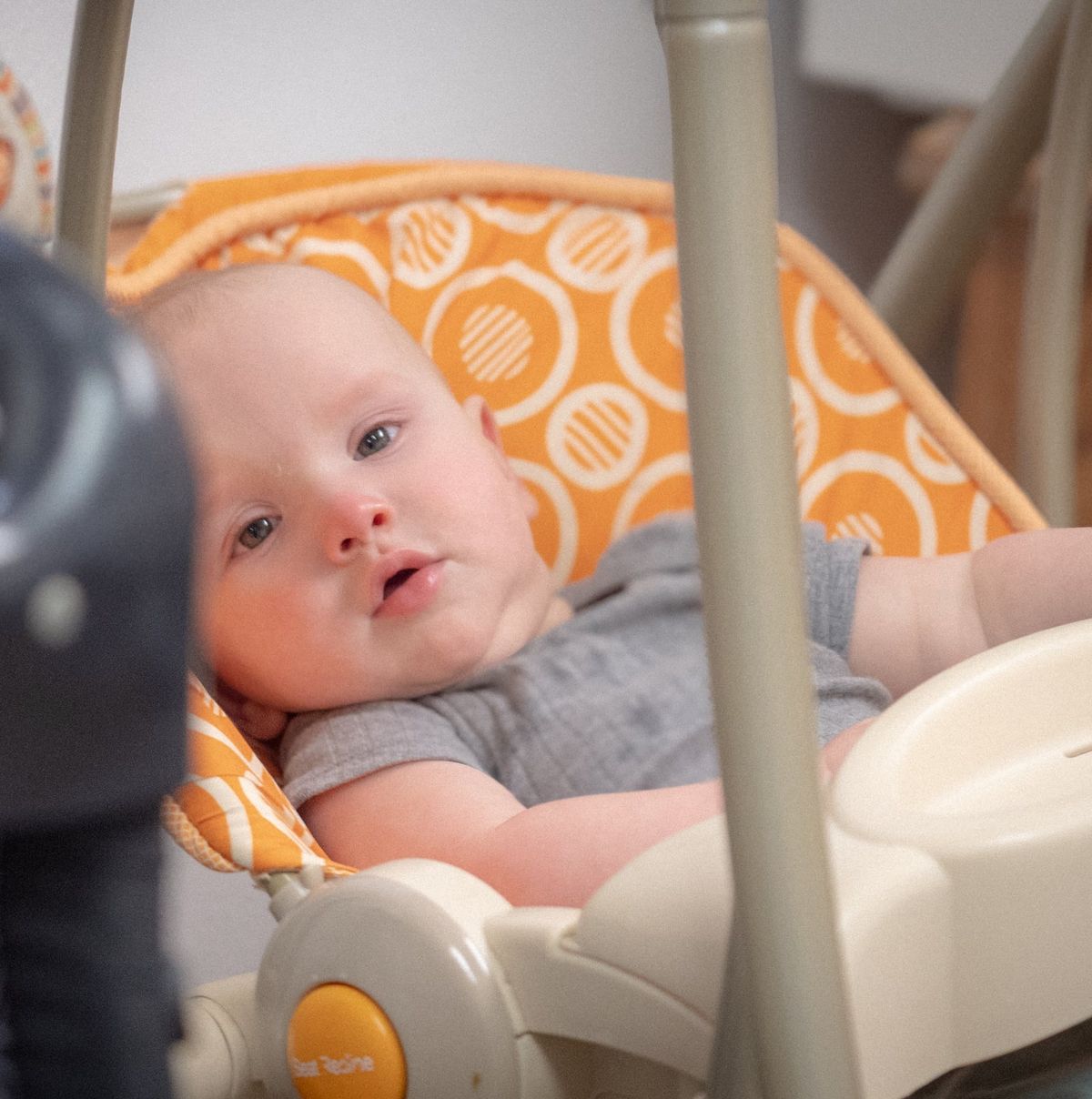 A baby resting in an infant swing at Noah's Ark Daycare