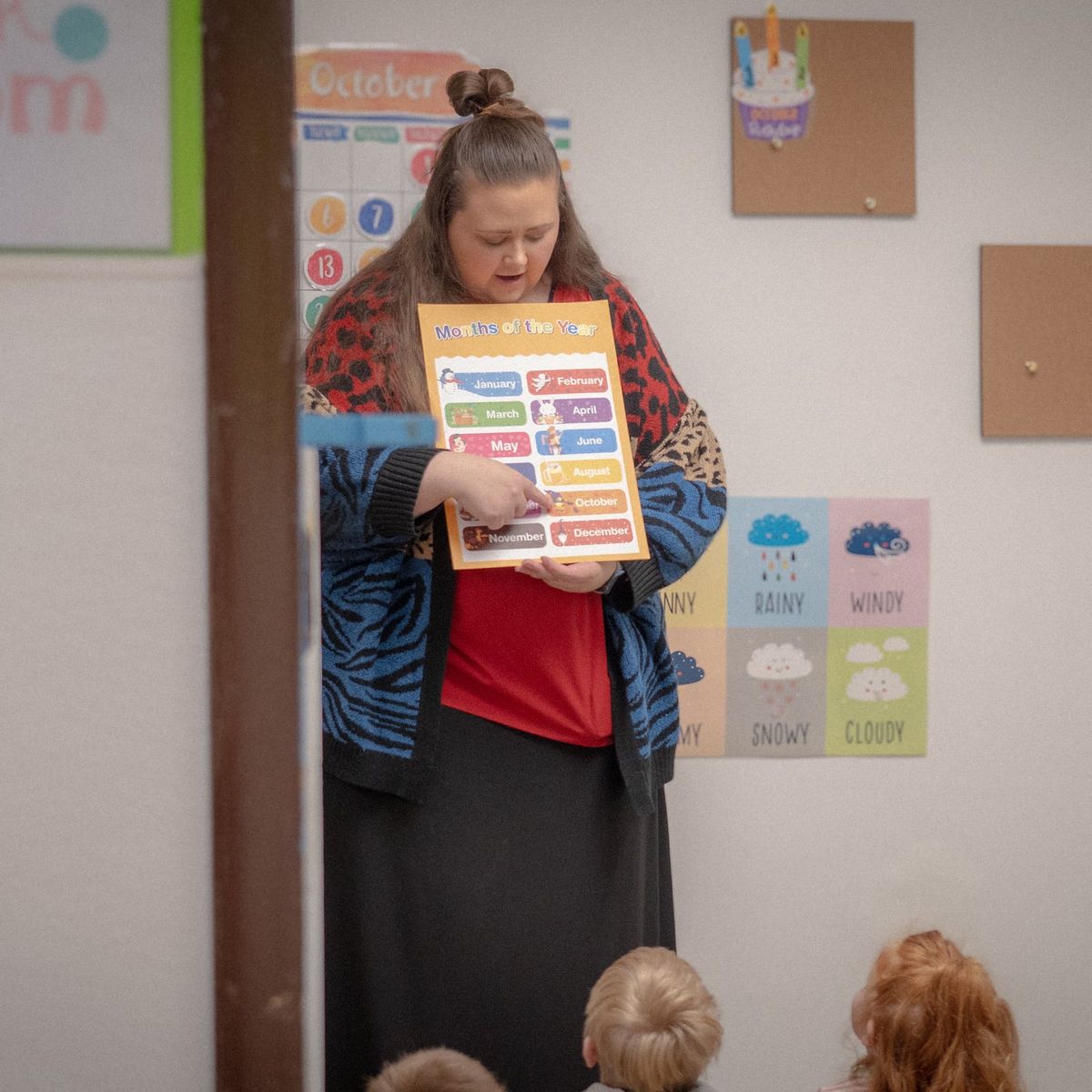 A Noah's Ark teacher showing the months of the year to preschoolers in the Pre-K room