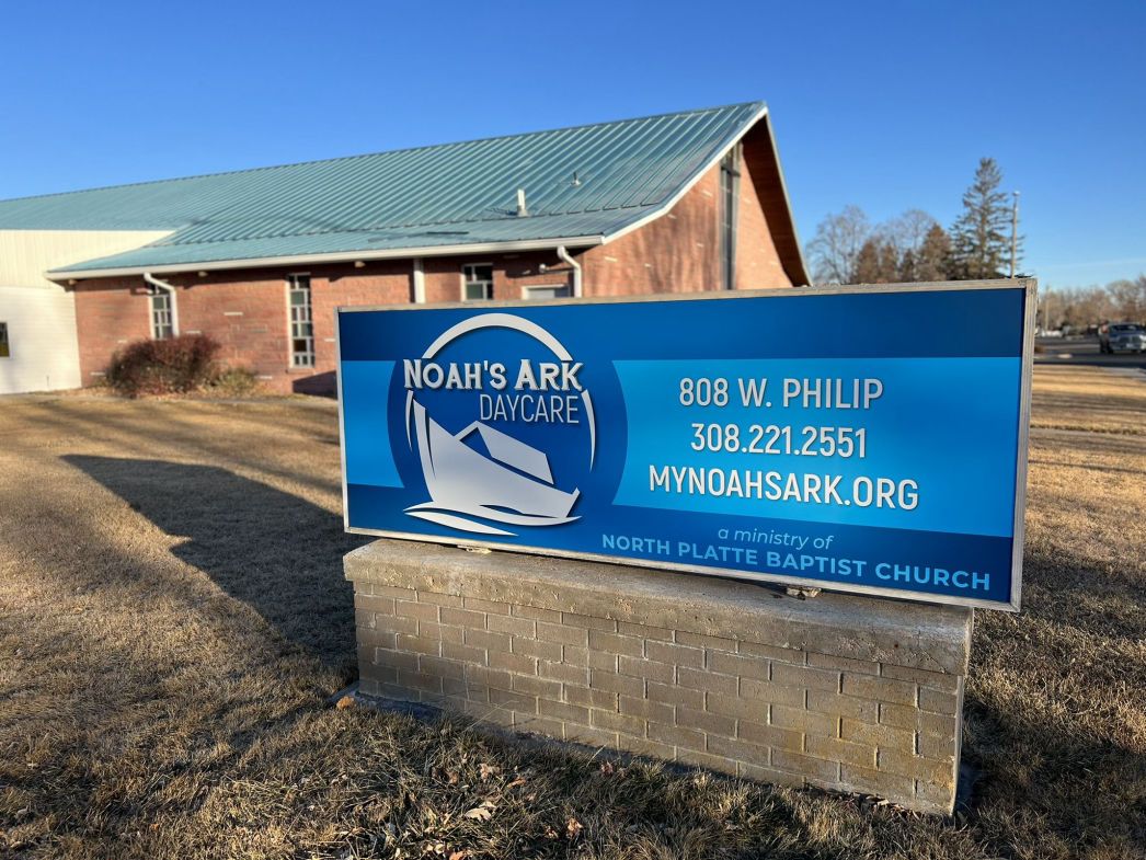 The blue Noah's Ark Daycare sign in front of the brick building on W. Philip Ave.